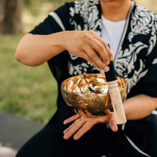 A man plays a singing bowl